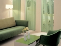 green-vertical-window-blind-beside-the-sofa-and-flexible-table-blend-with-drum-floor-lamp-in-the-white-room